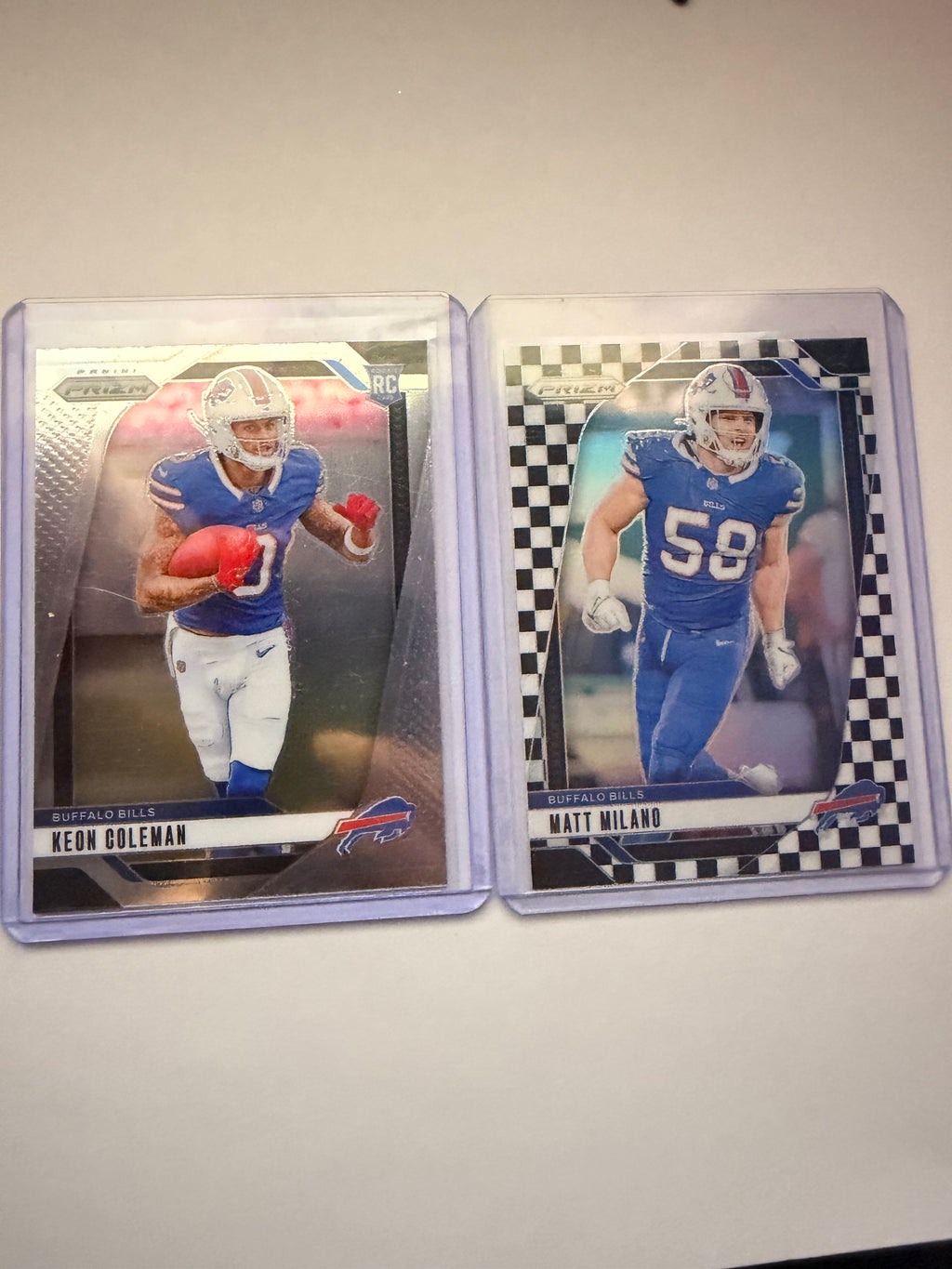 2024 Panini Prizm Keon Coleman RC Base + Matt Milano Checkerboard Parallel – Buffalo Bills lot. Rookie card plus short-print checkerboard veteran.